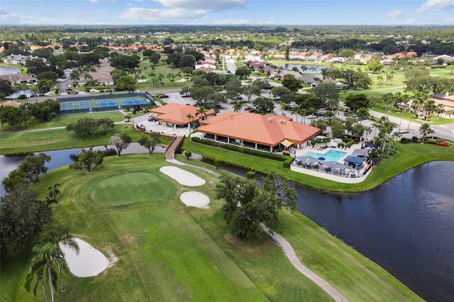 birds eye view of property with a water view and golf course view