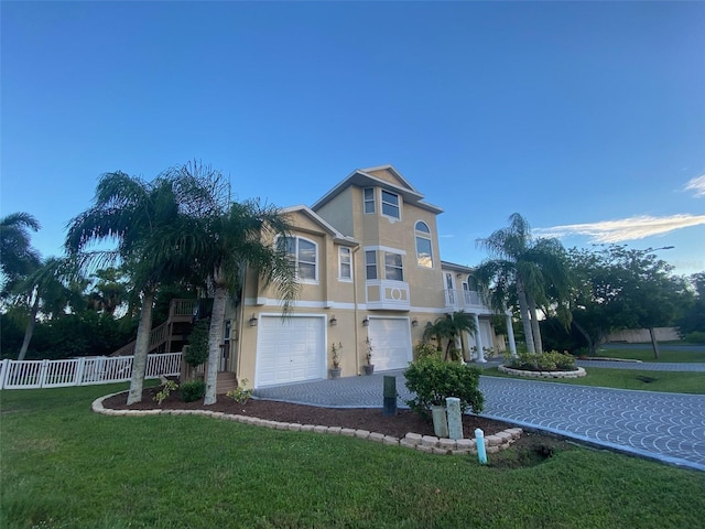 view of front of home with a front yard and a garage