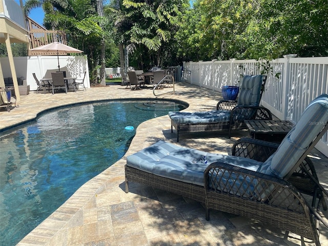 view of swimming pool featuring a patio area