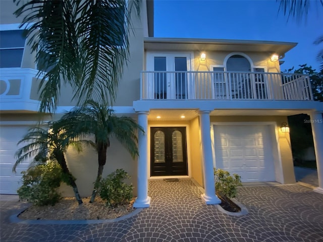 view of front facade featuring a garage and french doors