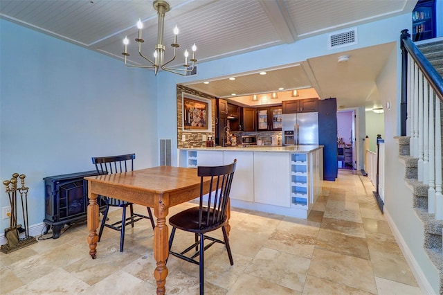 dining space with a wood stove, wooden ceiling, and a notable chandelier