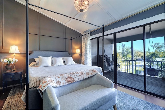 bedroom with access to exterior, hardwood / wood-style floors, and lofted ceiling