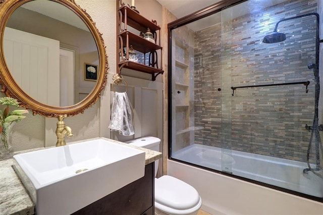 full bathroom featuring vanity, toilet, and enclosed tub / shower combo