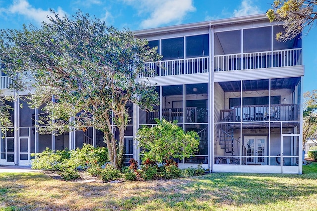 rear view of property with a yard