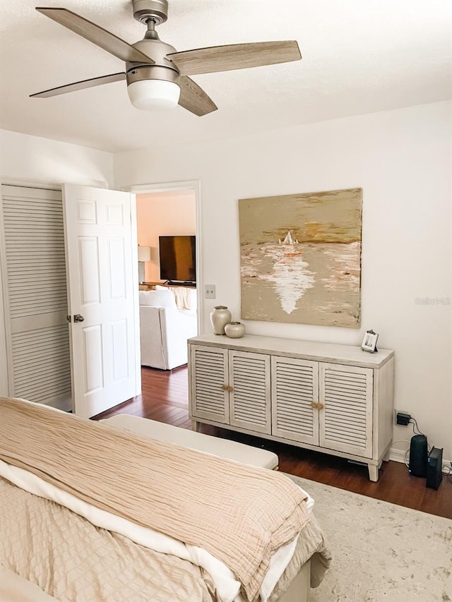 bedroom with ceiling fan, dark hardwood / wood-style flooring, and a closet