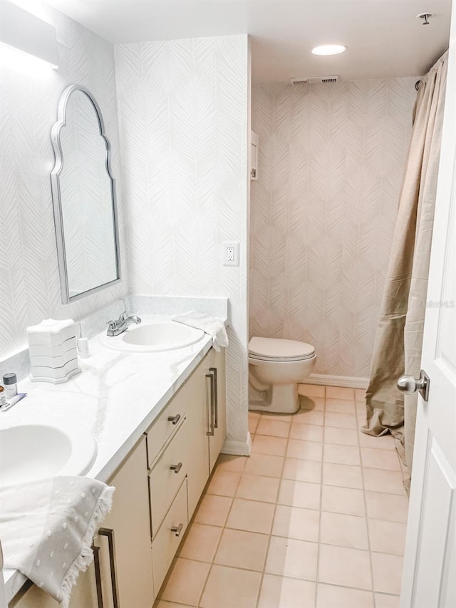 bathroom featuring tile patterned floors, vanity, and toilet