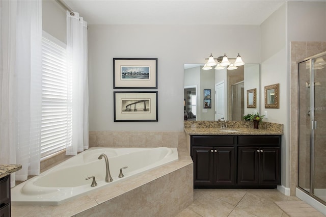 bathroom with a stall shower, tile patterned floors, vanity, and a bath