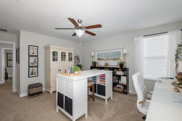 office with ceiling fan, light colored carpet, and a textured ceiling