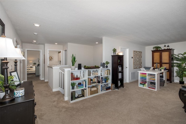 recreation room featuring recessed lighting, visible vents, light colored carpet, a textured ceiling, and baseboards