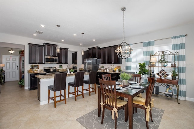 tiled dining space with a chandelier