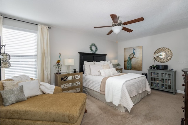 bedroom with a textured ceiling, ceiling fan, and carpet flooring