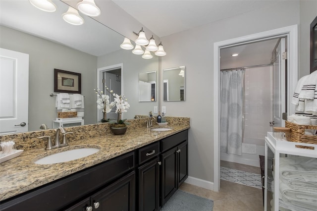 bathroom with tile patterned flooring, vanity, and walk in shower