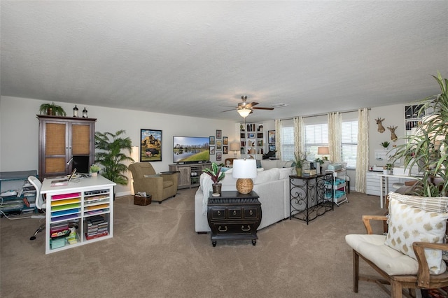 carpeted living room with a textured ceiling and a ceiling fan