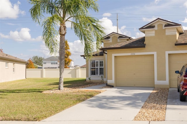 view of front of property with a garage, concrete driveway, fence, a front lawn, and stucco siding