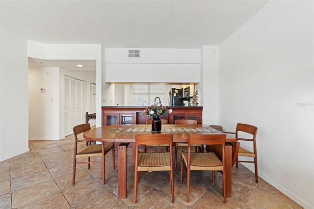 dining area featuring a textured ceiling