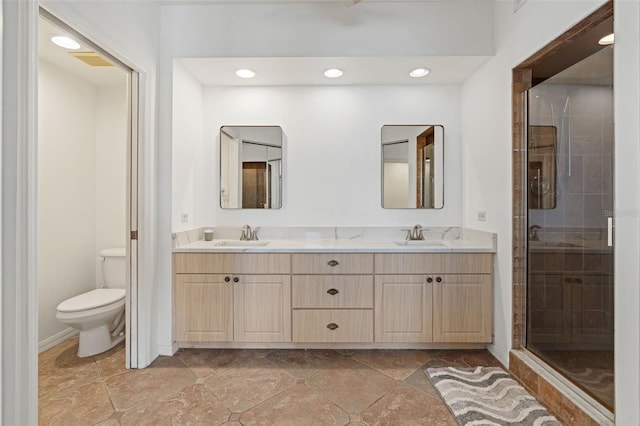 bathroom featuring walk in shower, vanity, and toilet