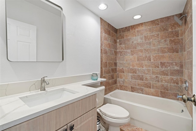 full bathroom with vanity, toilet, and tiled shower / bath