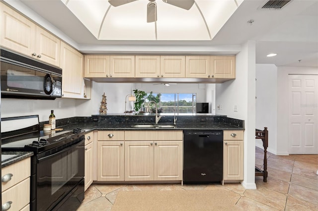 kitchen with black appliances, ceiling fan, dark stone countertops, and sink