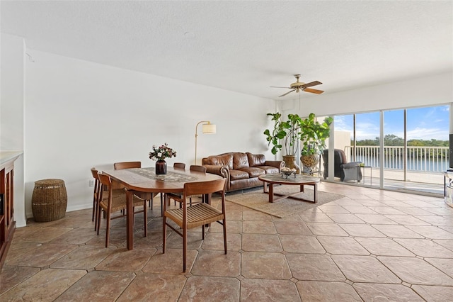 dining area featuring a textured ceiling and ceiling fan