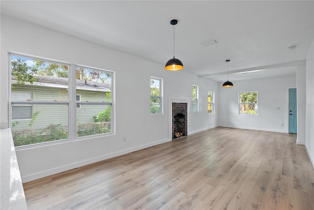 unfurnished living room with a fireplace and light hardwood / wood-style flooring