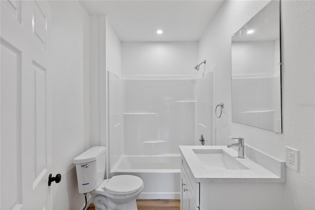 full bathroom featuring hardwood / wood-style floors, vanity, toilet, and shower / bathtub combination