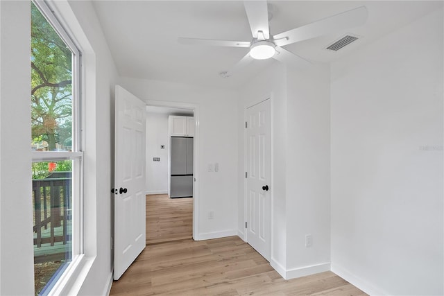 unfurnished room with ceiling fan and light wood-type flooring