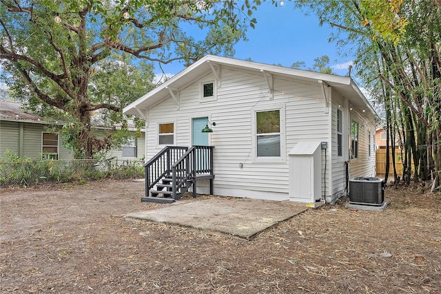 rear view of house with cooling unit