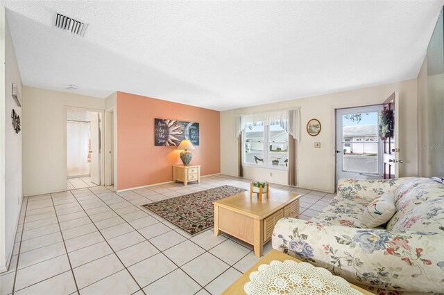 tiled living room with a textured ceiling