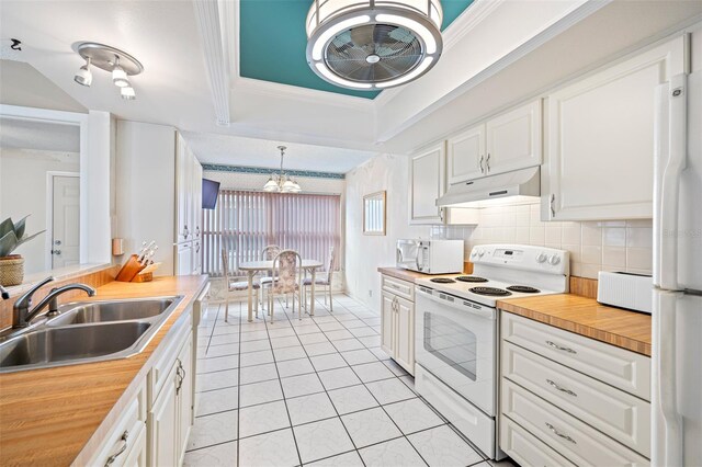 kitchen with sink, white cabinets, decorative light fixtures, and white appliances