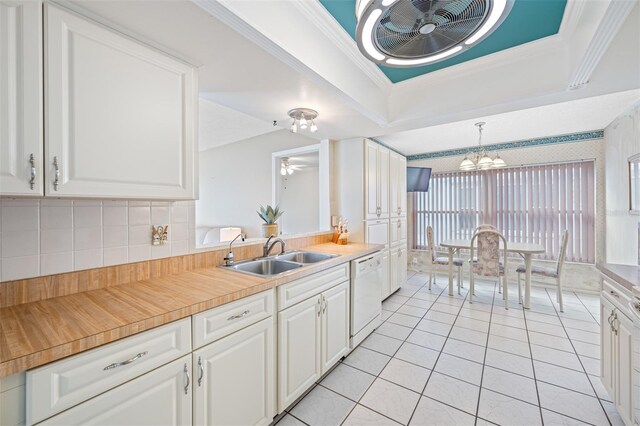 kitchen with white dishwasher, ceiling fan, sink, decorative light fixtures, and white cabinetry