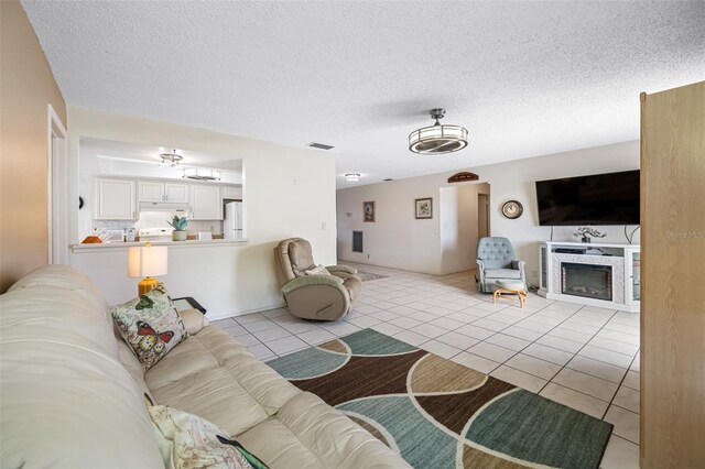 tiled living room with a textured ceiling