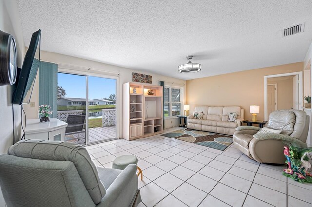 tiled living room with a textured ceiling