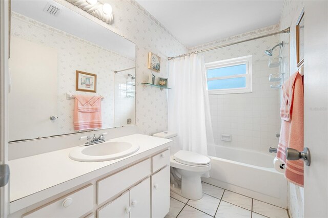 full bathroom featuring toilet, tile patterned floors, vanity, and shower / tub combo with curtain