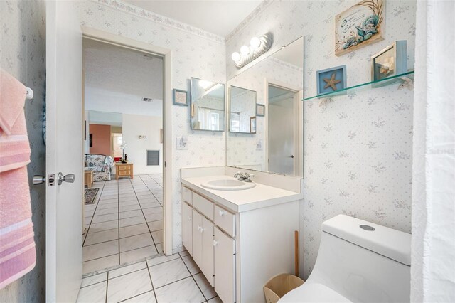 bathroom featuring tile patterned floors, vanity, and toilet