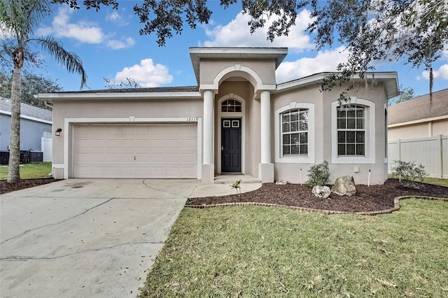 view of front of house featuring a garage and a front lawn