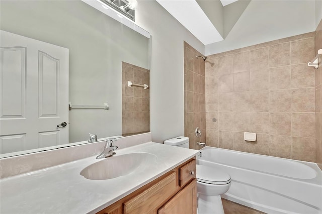 full bathroom featuring tile patterned floors, vanity, toilet, and tiled shower / bath