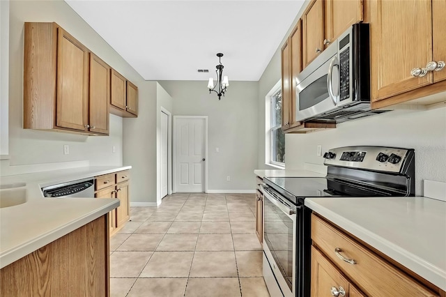 kitchen with a chandelier, appliances with stainless steel finishes, light tile patterned floors, and pendant lighting