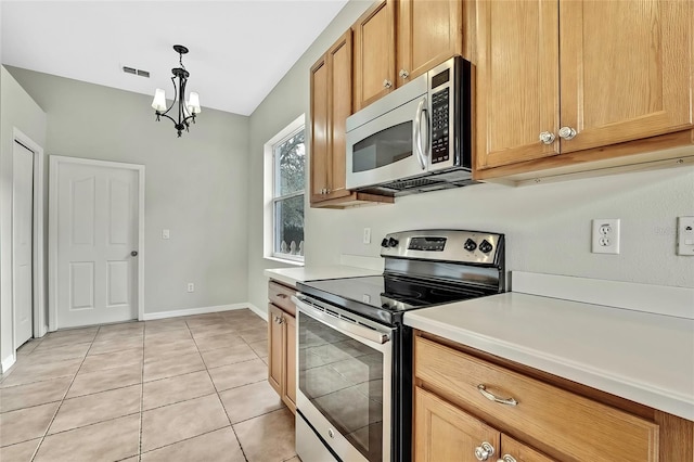 kitchen with light tile patterned floors, stainless steel appliances, decorative light fixtures, and an inviting chandelier