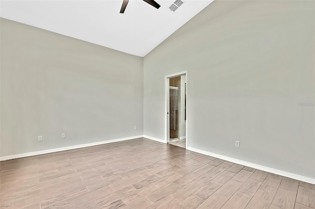 empty room with light hardwood / wood-style floors, high vaulted ceiling, and ceiling fan