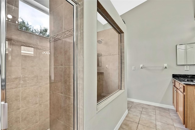 bathroom featuring tile patterned flooring, vanity, and walk in shower