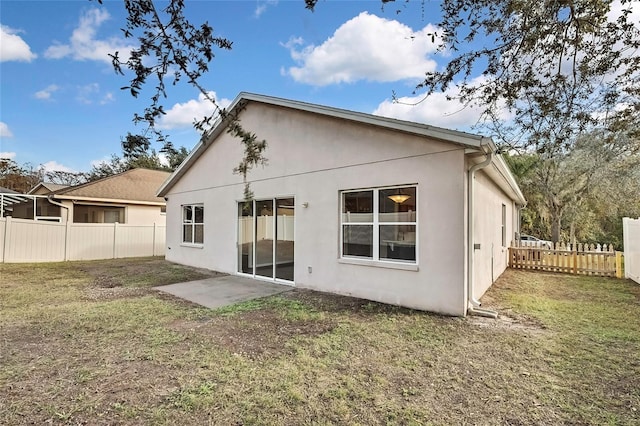 rear view of property with a yard