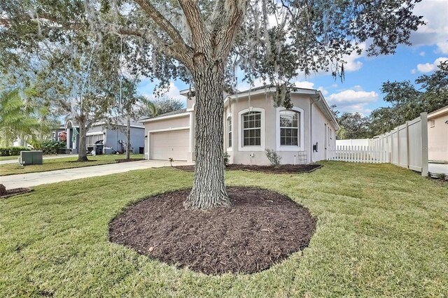 view of front of house with a garage and a front lawn