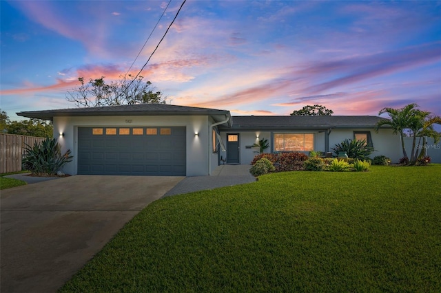 view of front of house with a yard and a garage