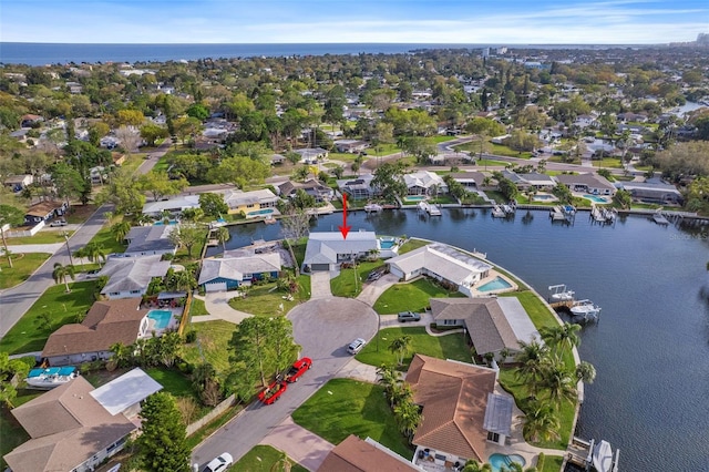 drone / aerial view featuring a residential view and a water view