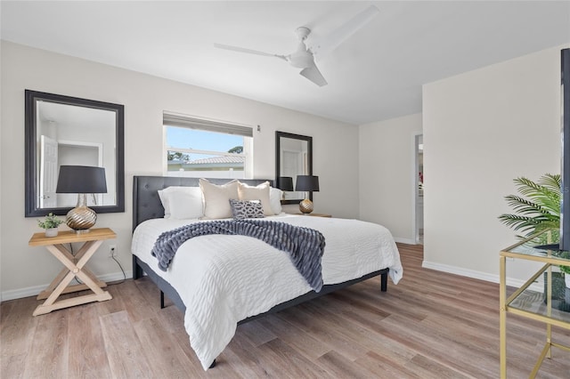bedroom with baseboards, a ceiling fan, and wood finished floors