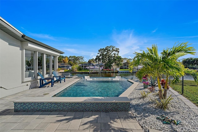 view of pool featuring a patio, a dock, and a water view