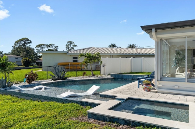 outdoor pool with a patio area, a fenced backyard, an in ground hot tub, and a lawn