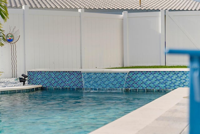 view of swimming pool with fence