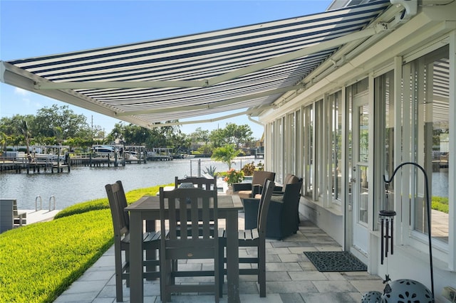 view of patio / terrace featuring a water view and outdoor dining area