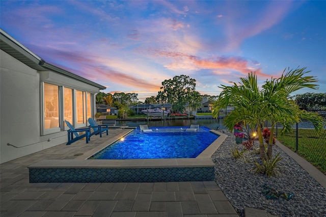 outdoor pool featuring fence and a patio